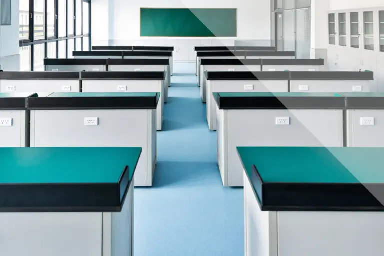Classroom with dark green table surfaces