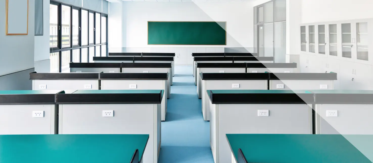 Classroom with dark green table surfaces