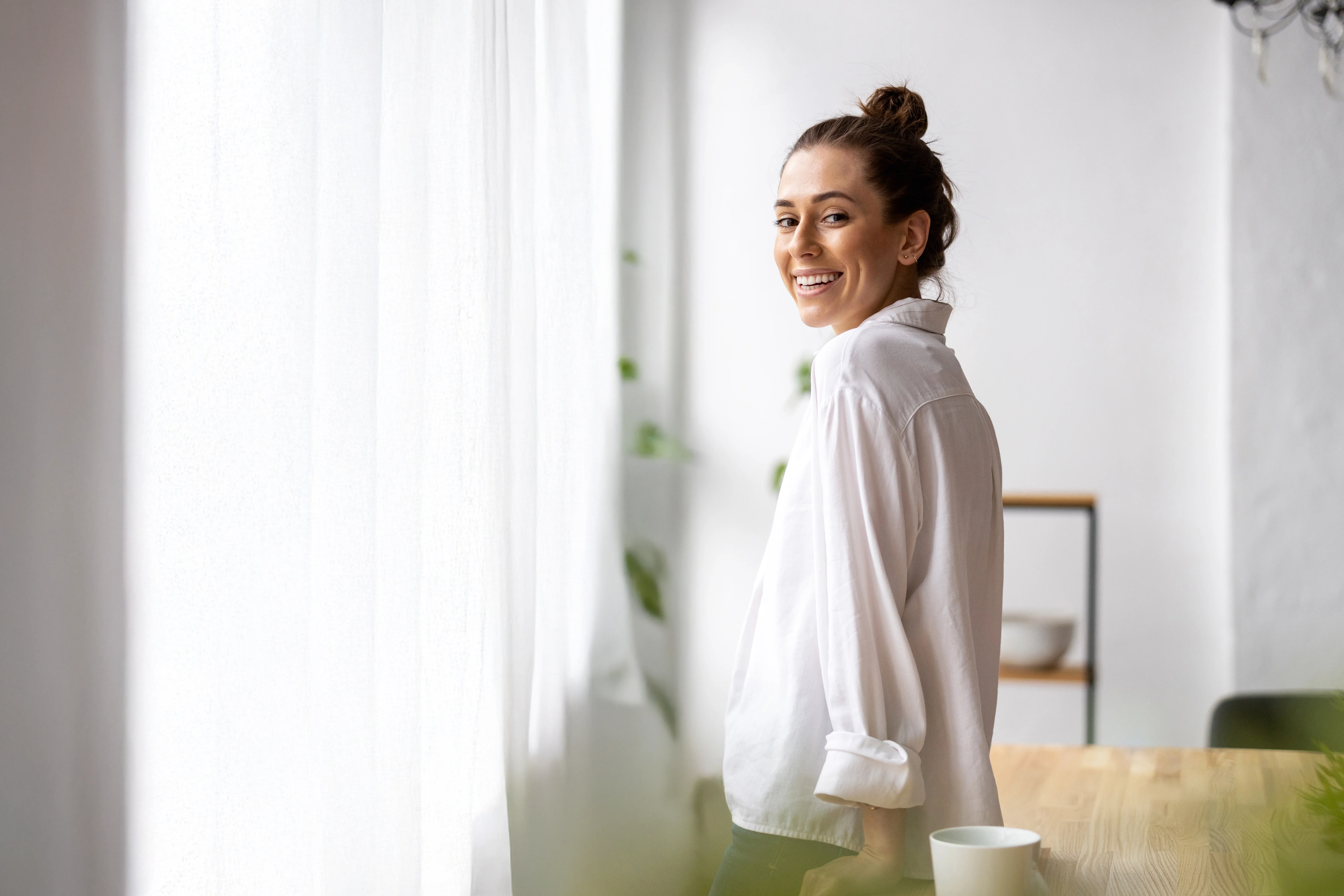young woman who clearly feels comfortable in her home