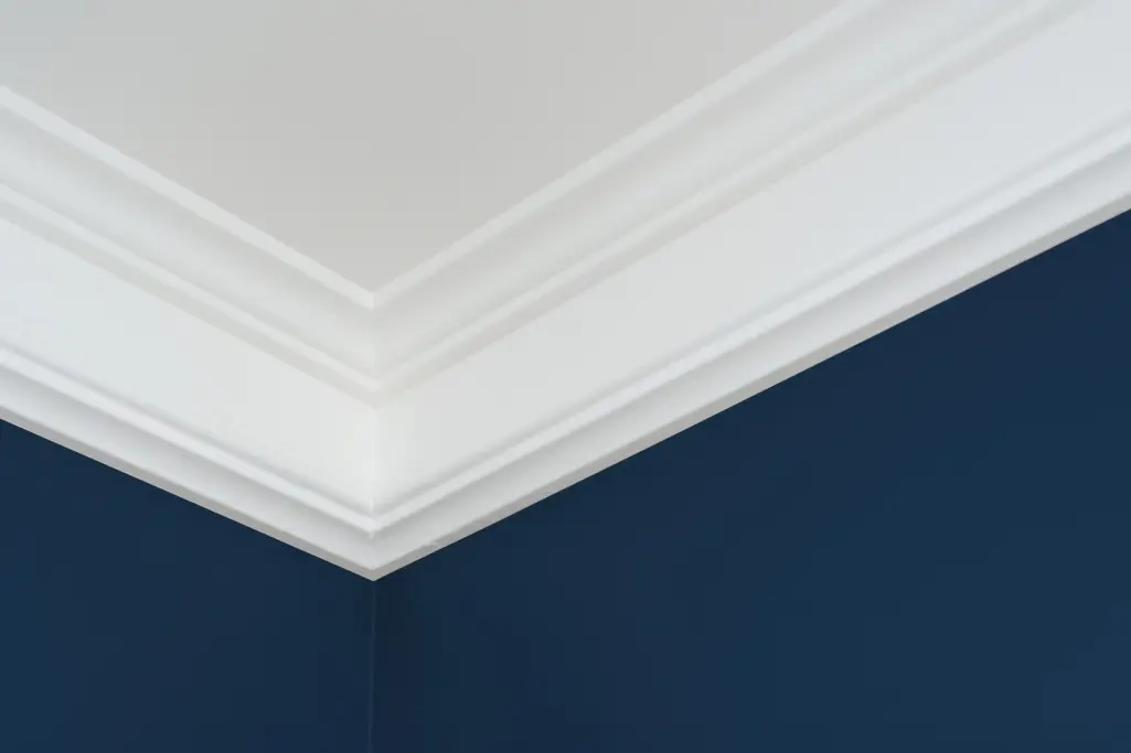 White ceiling corner with transition to a dark wall