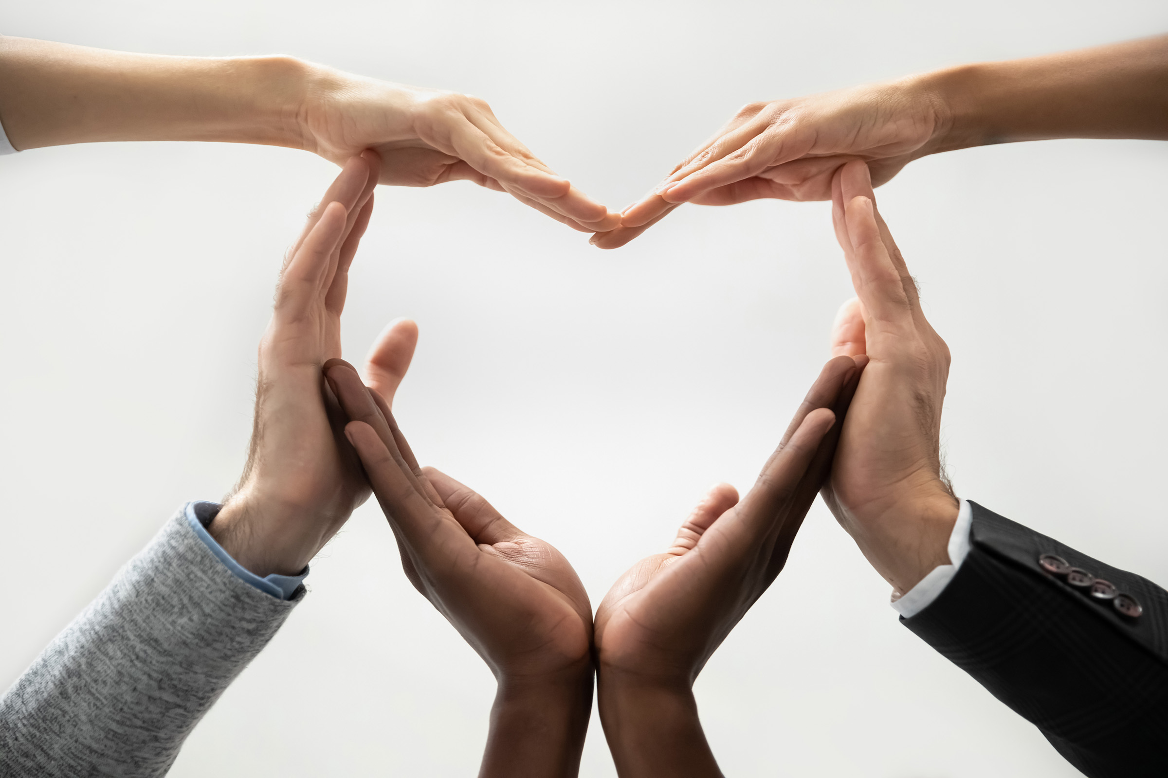 Team with heart: 6 hands form a heart; Work at SÜDWEST