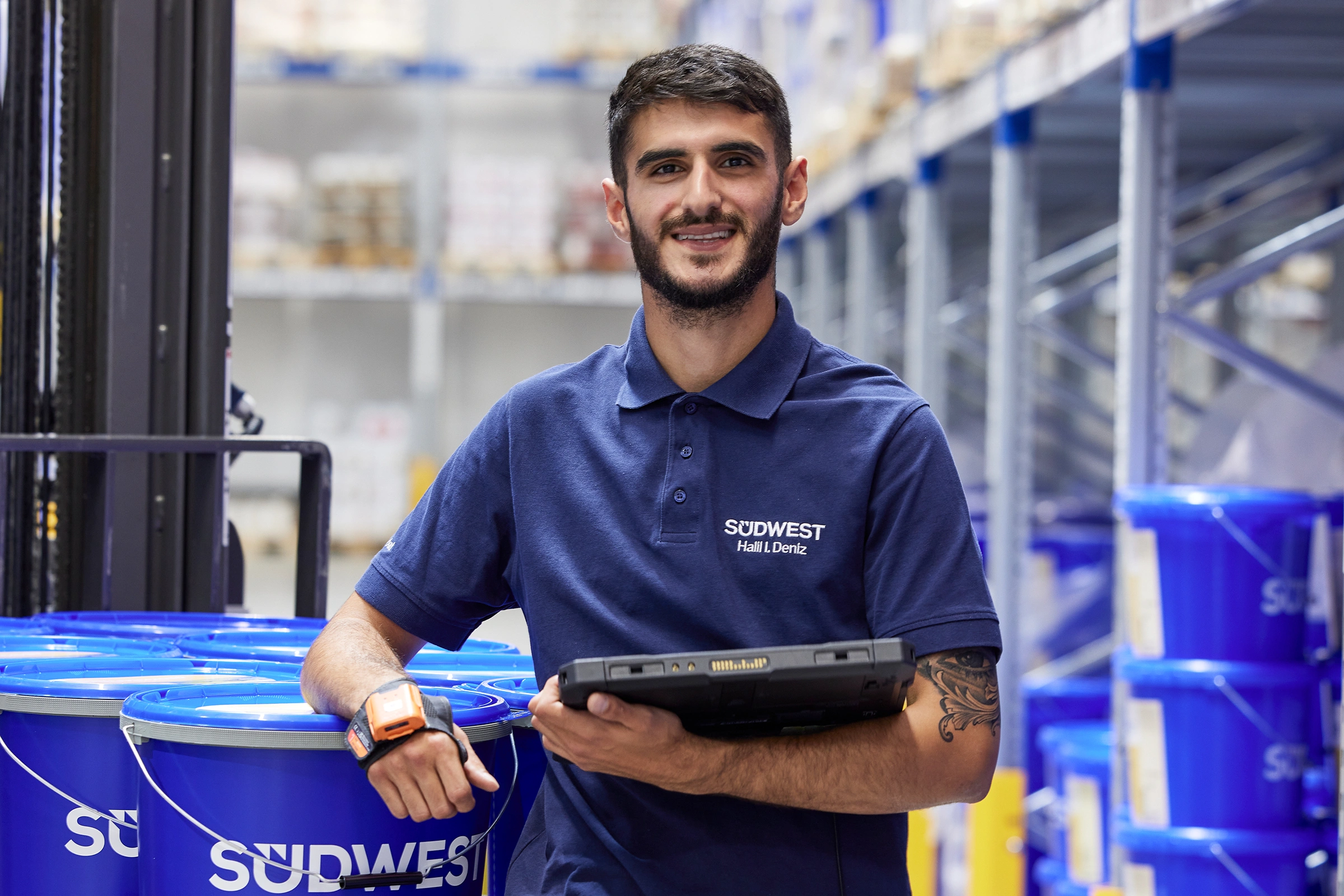 Training as a warehouse specialist; trainee with the forklift in the warehouse