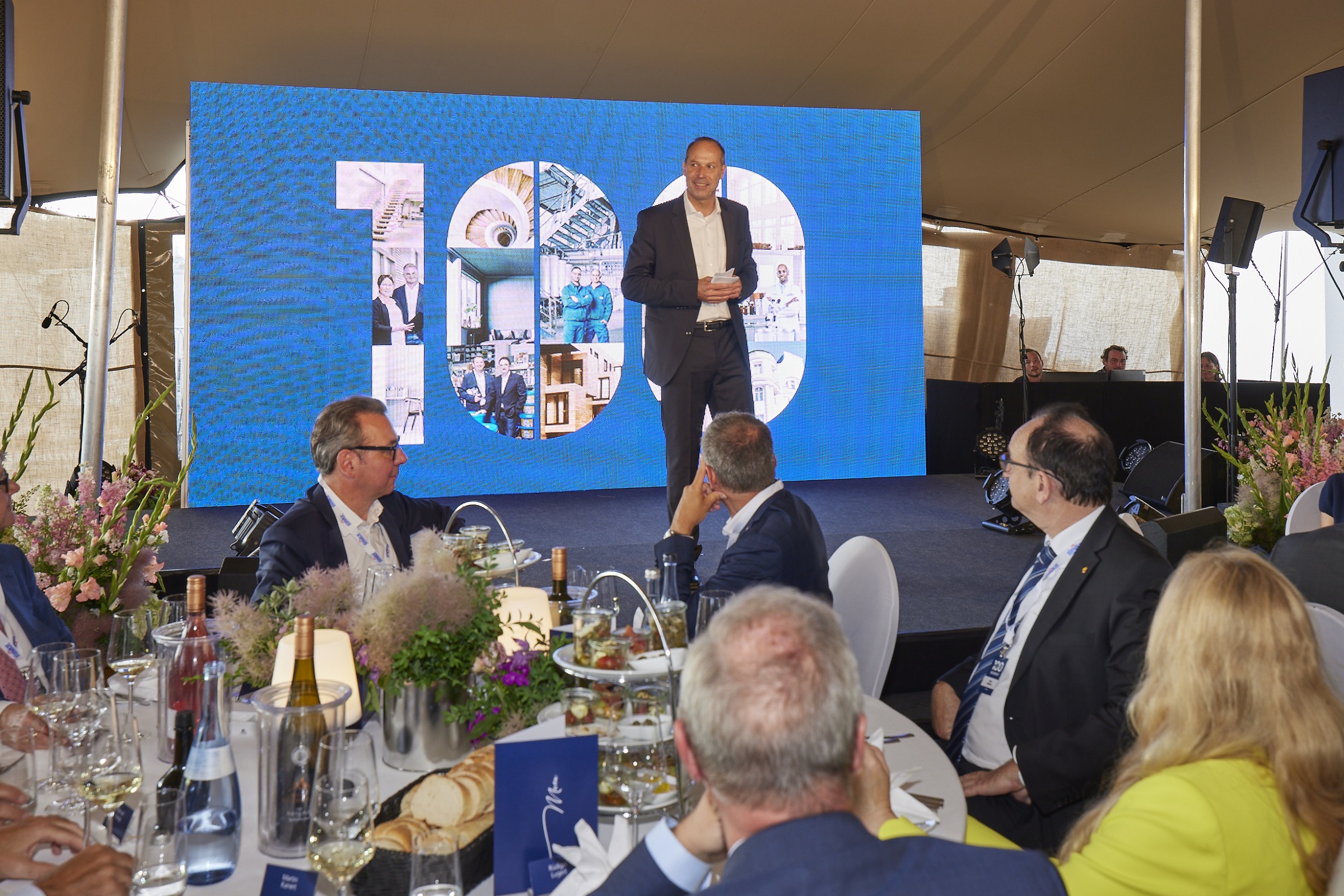 CEO on stage during his speech at the 100-year celebration