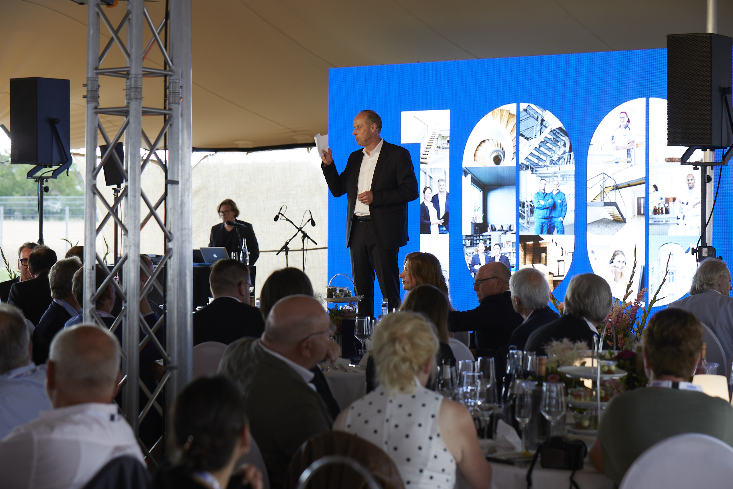 CEO on stage during his speech at the 100-year celebration