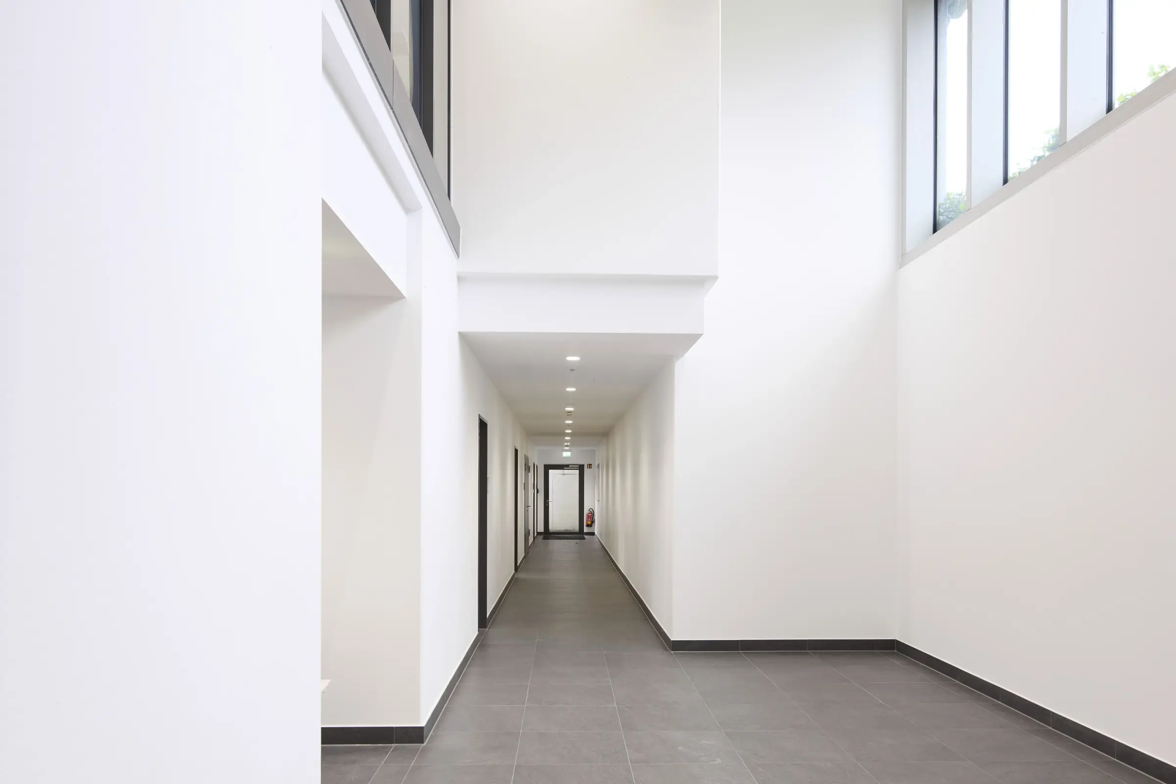  corridor with high white walls