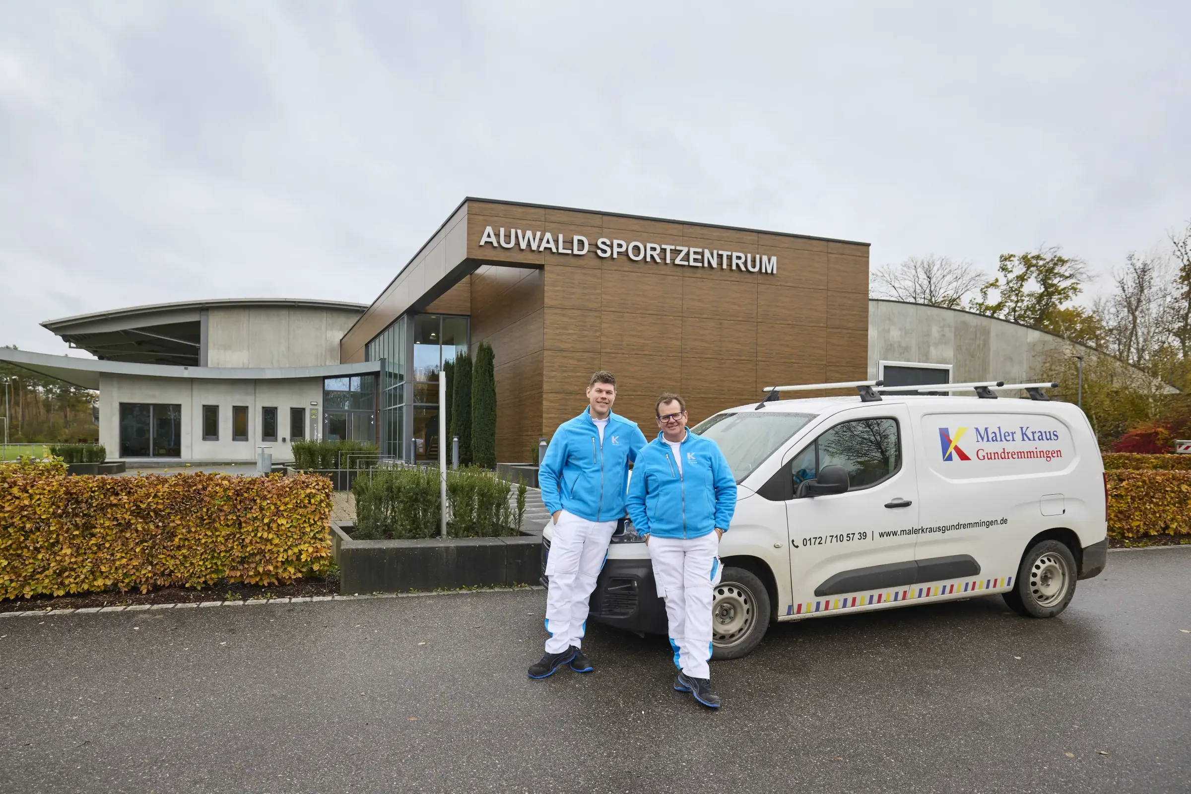 Painting team in front of the sports hall - exterior view